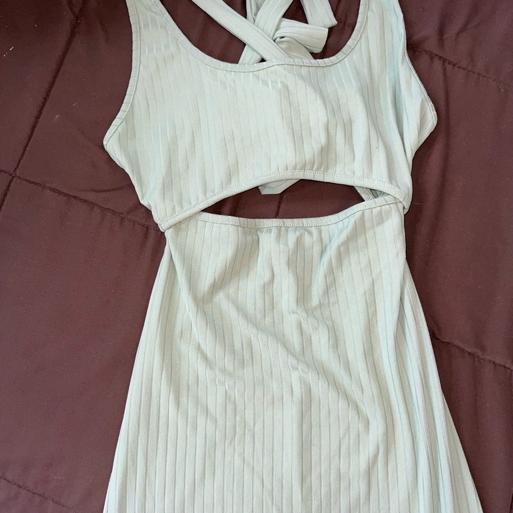 Light green midi length, body con dress, with a cut out and tie back detail